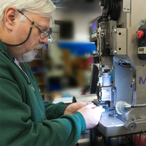 John Belovarac, Operation Manager, operating a Mini Applicator and 4 Ton Press, Mecal by Starn